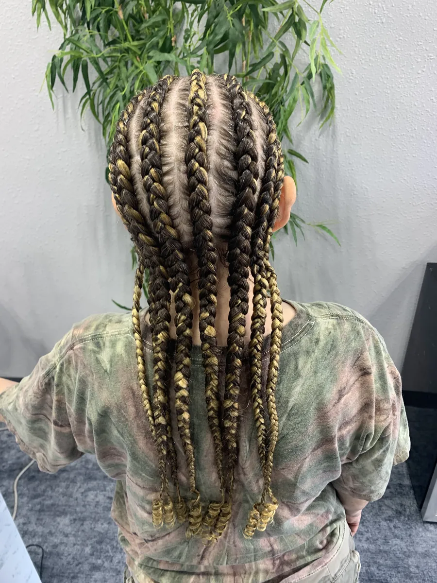 Cornrows feeding into long honey-blonde braids