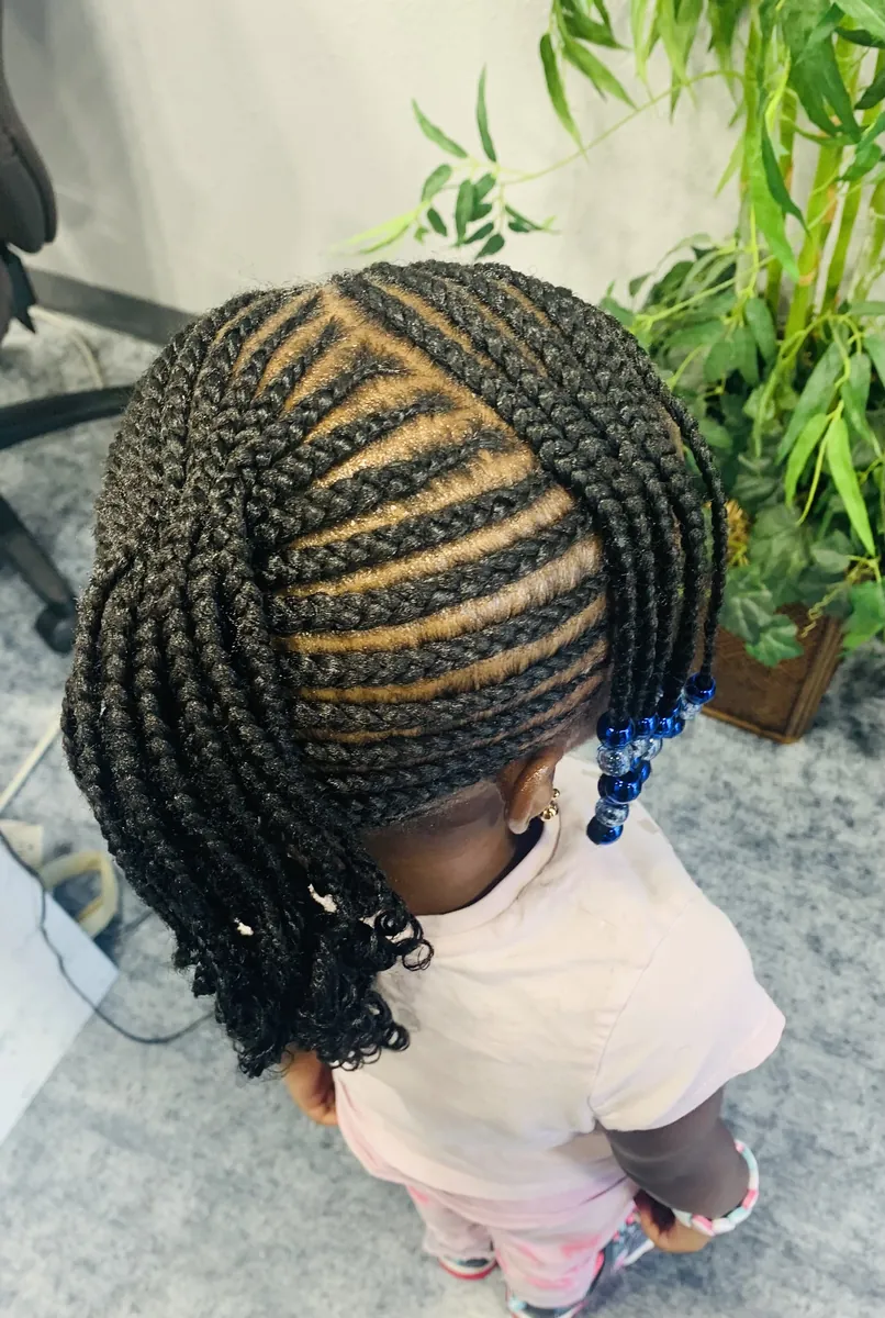Child's braids and twists finished with blue beads